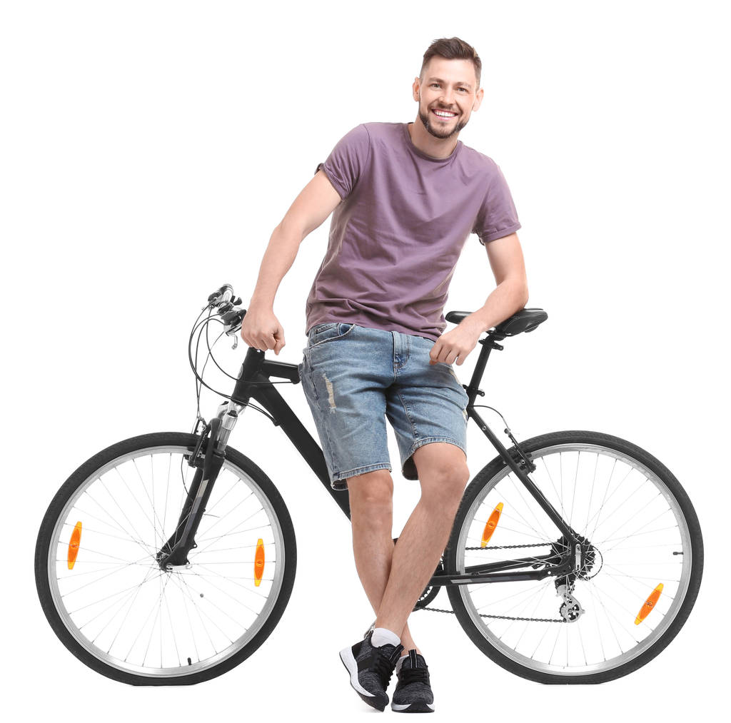 Όμορφος νεαρός άνδρας με ποδήλατο σε λευκό φόντο - Φωτογραφία, εικόνα