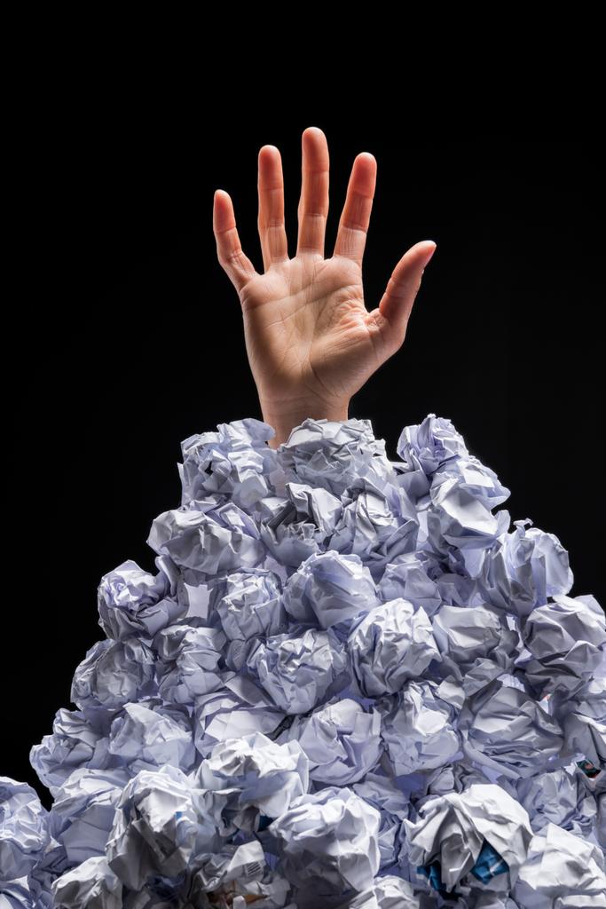 Hand reaching out from heap of papers - Photo, Image