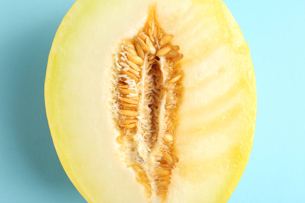 La mitad del melón jugoso sobre el fondo de color. Concepto de sexo
 - Foto, imagen