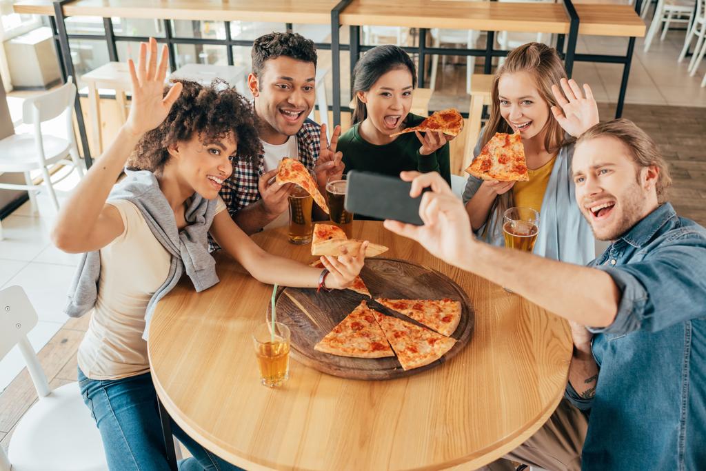 friends taking selfie with pizza at cafe  - Photo, Image