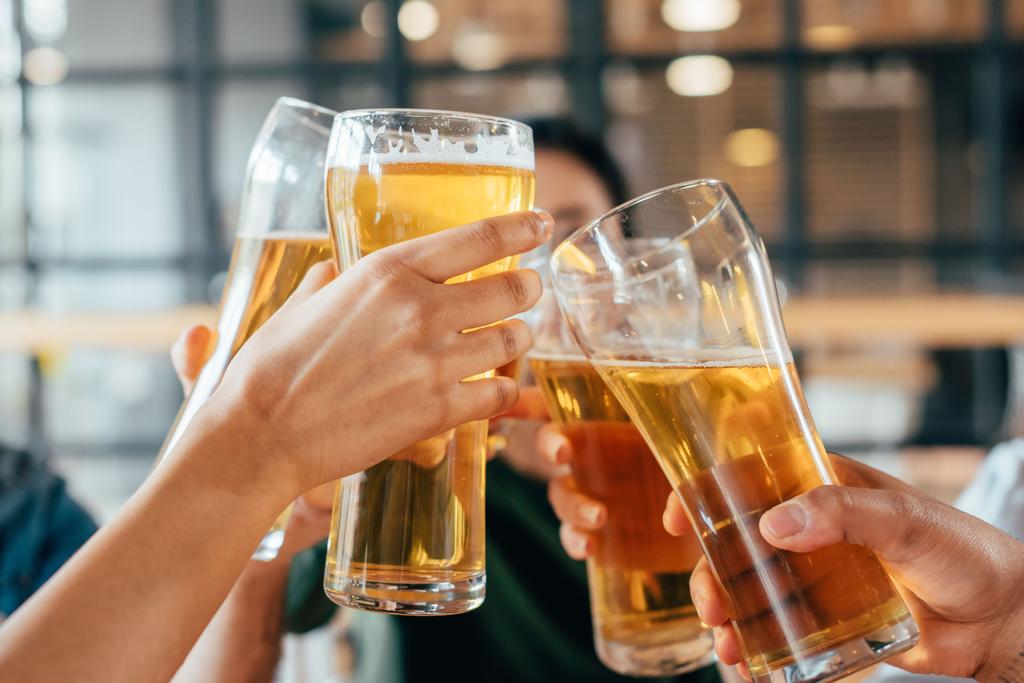 friends clinking with beer in cafe - Photo, Image