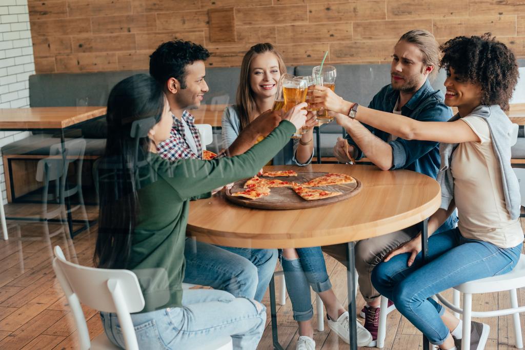 friends clinking with beer in cafe - Photo, Image