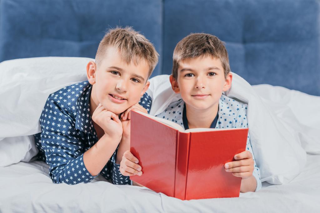 boys reading book together - Photo, Image