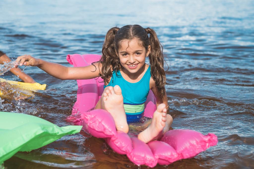 little girl on inflatable mattresses - Photo, Image