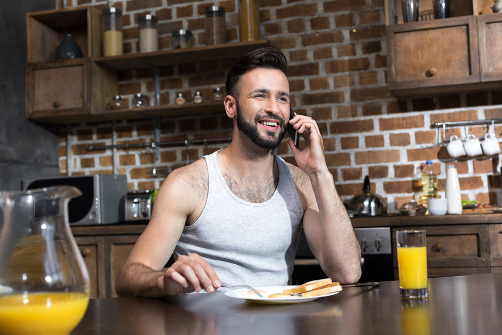 homme utilisant smartphone pendant le petit déjeuner
 - Photo, image