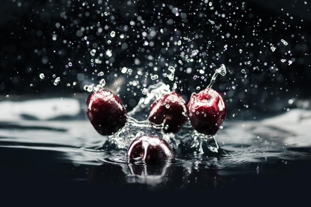 ripe cherries falling in water - Photo, Image