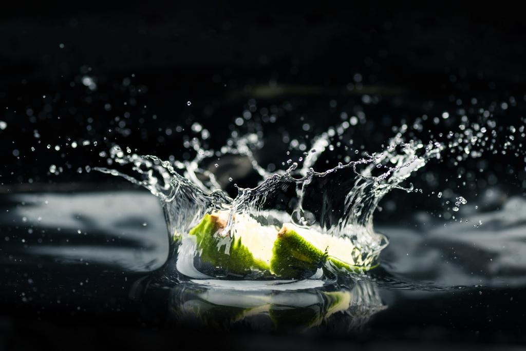 fatias de limão caindo na água
 - Foto, Imagem