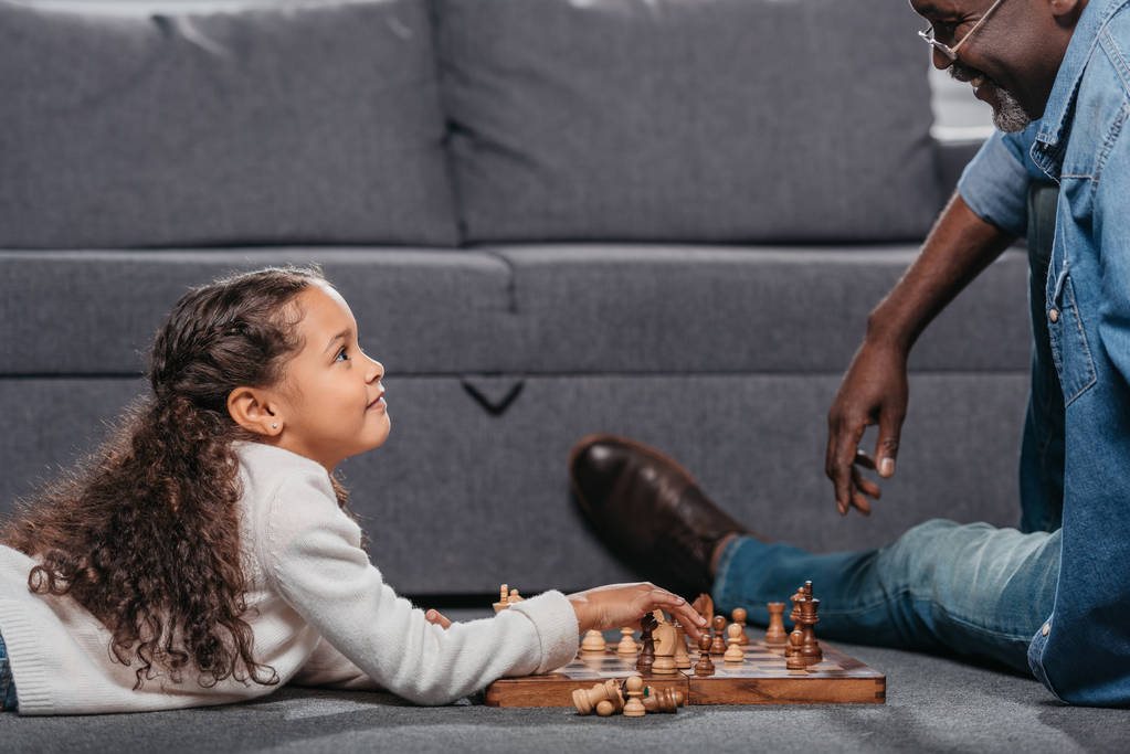 girl playing chess with father  - Photo, Image