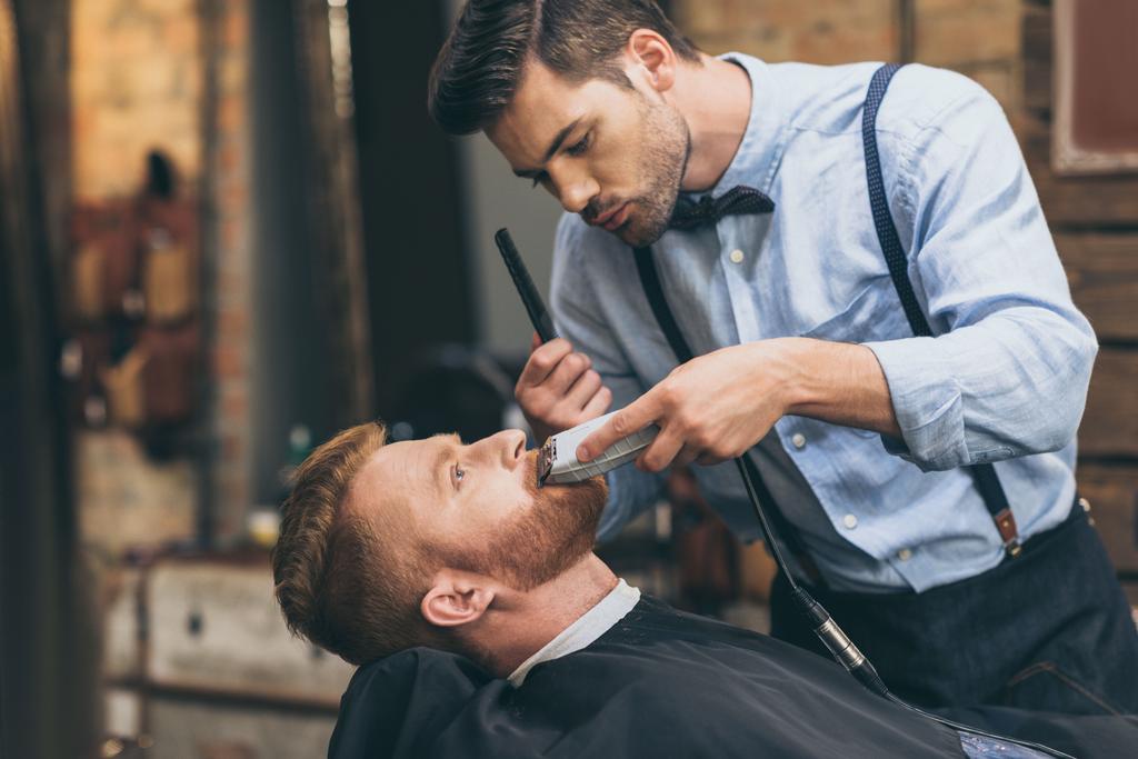 barber trimming customers beard - Photo, Image