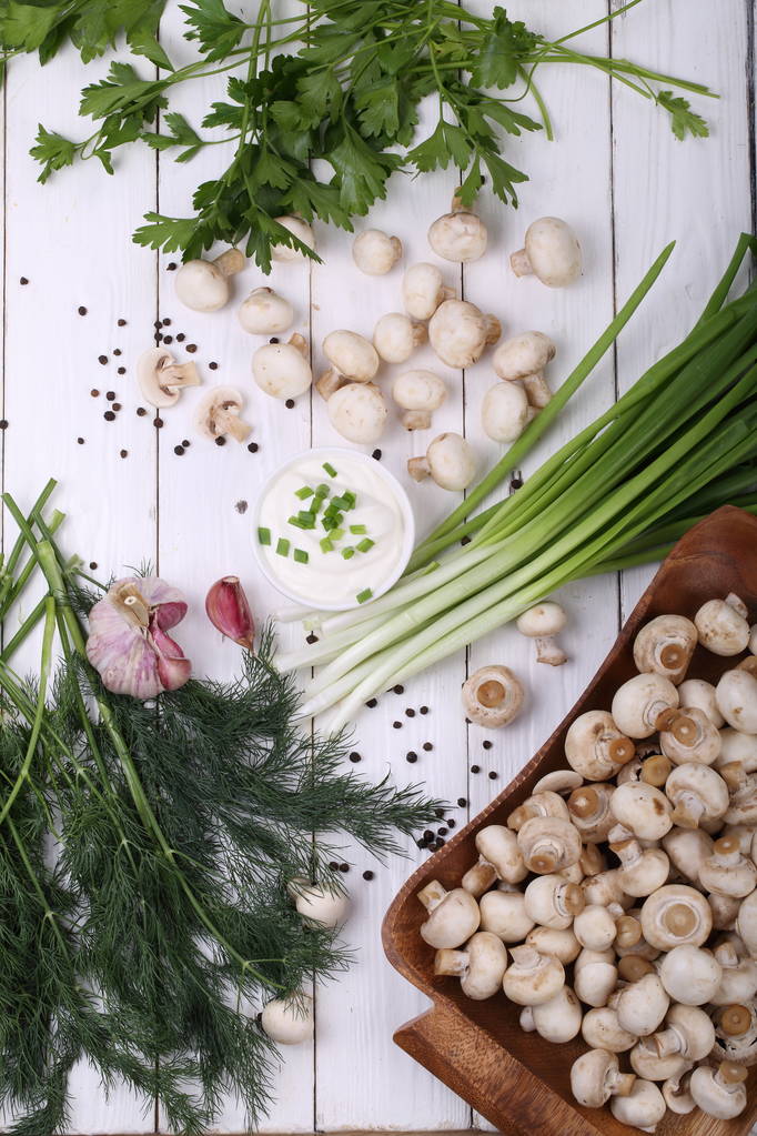fresh mushrooms and greens on a white background - Valokuva, kuva