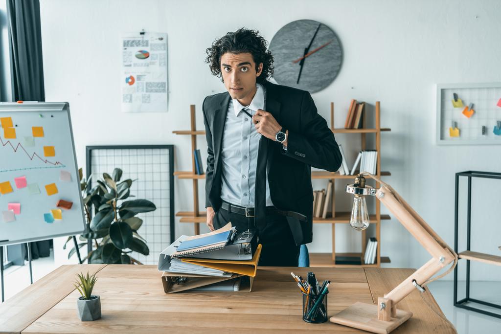 businessman tying necktie at workplace - Photo, Image