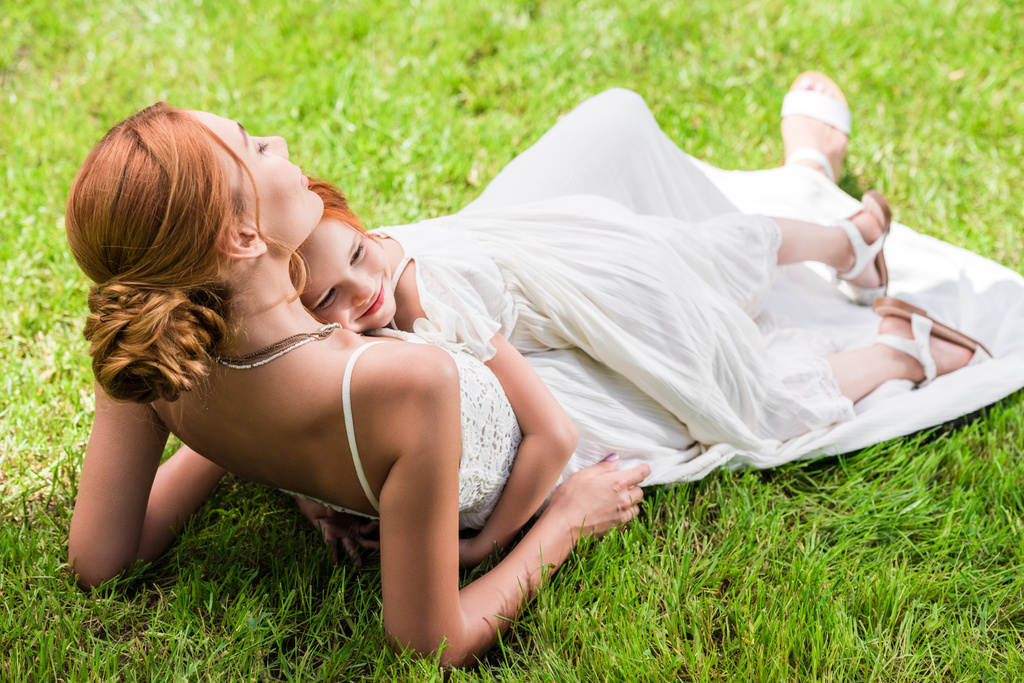 mother and daughter hugging at park - Photo, Image
