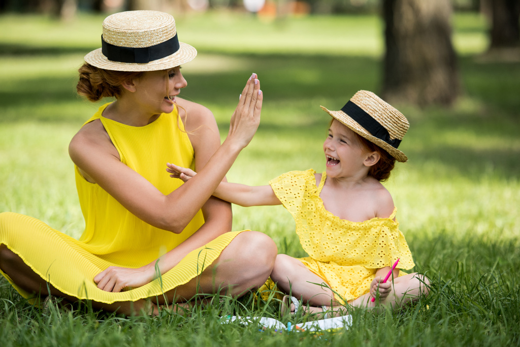 mother and daughter playing in park  - Photo, Image