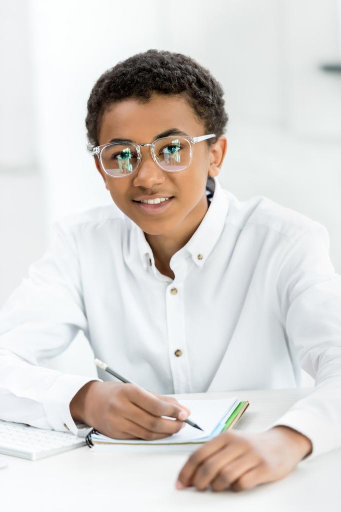 african american teenager doing homework - Photo, Image