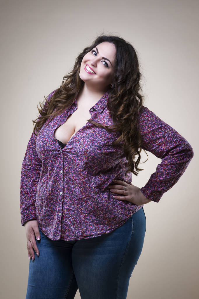 Plus size fashion model in casual clothes, fat woman on beige studio background, overweight female body - Photo, Image