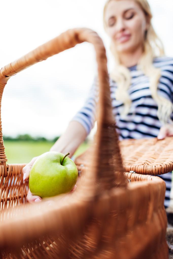 молода жінка з яблуком на пікніку
 - Фото, зображення