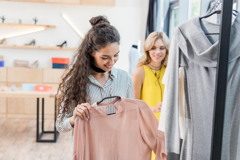 women choosing clothes in showroom - Photo, Image