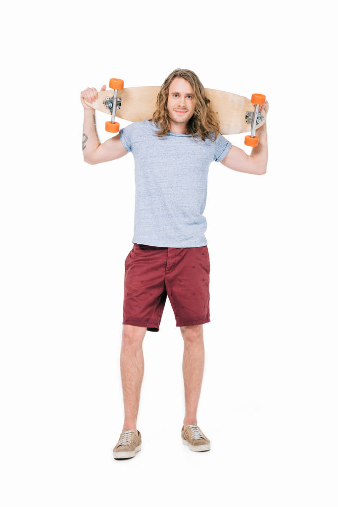 Knappe jongeman met skateboard - Foto, afbeelding