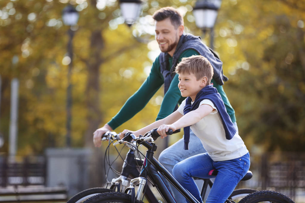 Apa és fia kerékpárral szabadban - Fotó, kép