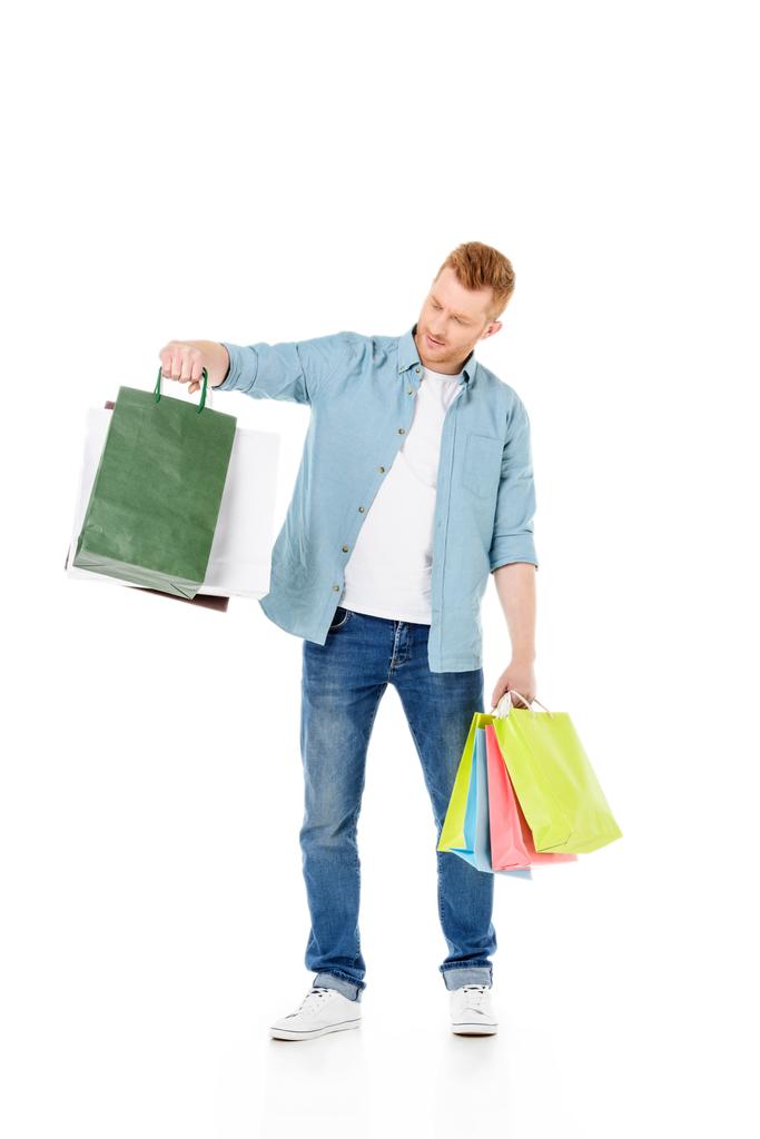 fiatal férfi bevásárlótáskákkal - Fotó, kép