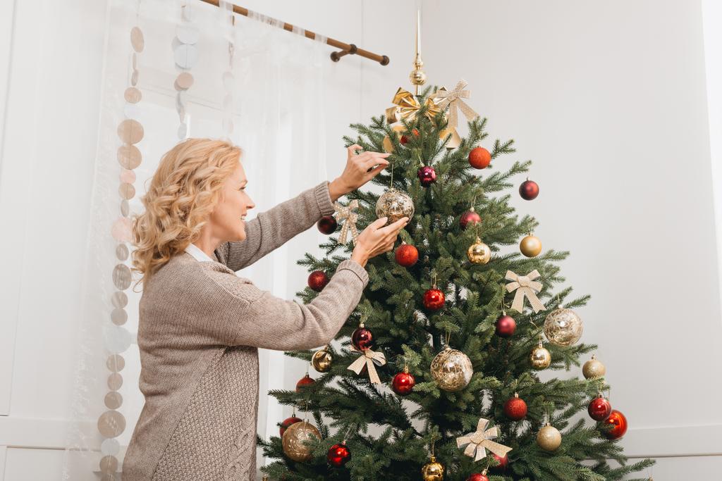 woman decorating christmas tree - Photo, Image