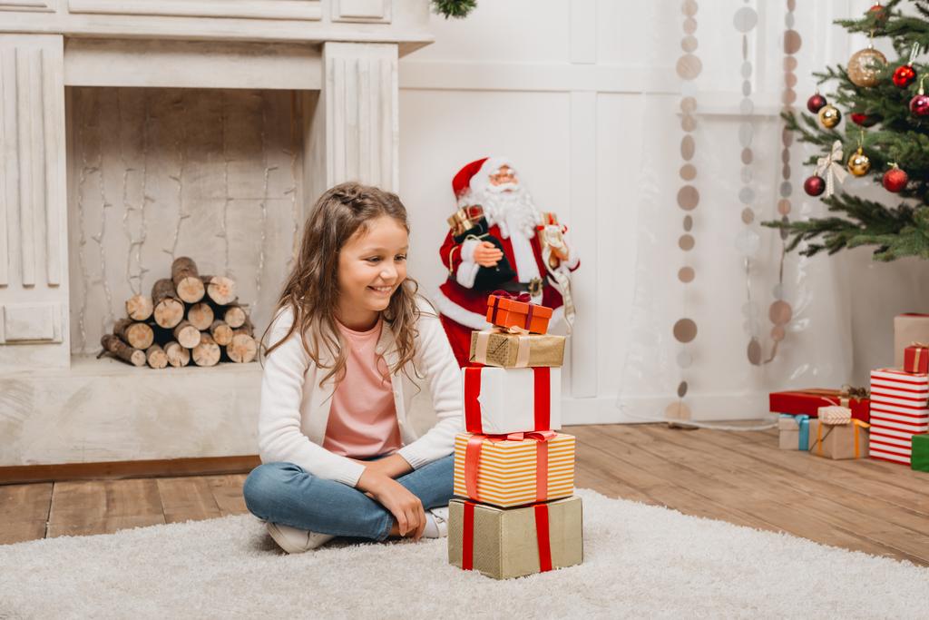 kid with stack of christmas gifts - Photo, Image