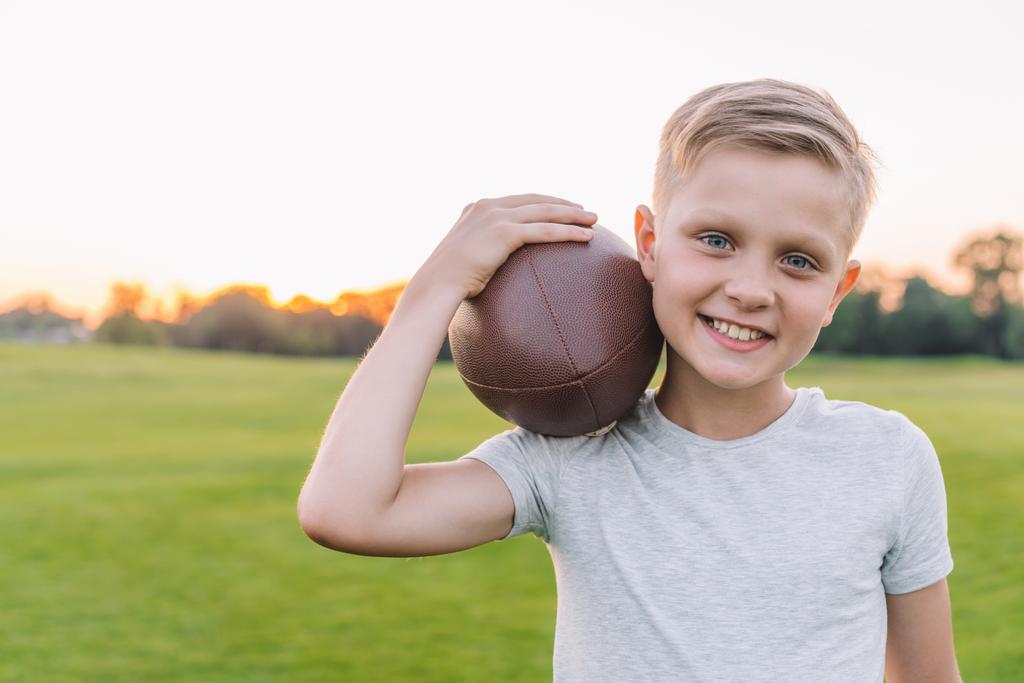 child with rugby ball in park - Photo, Image