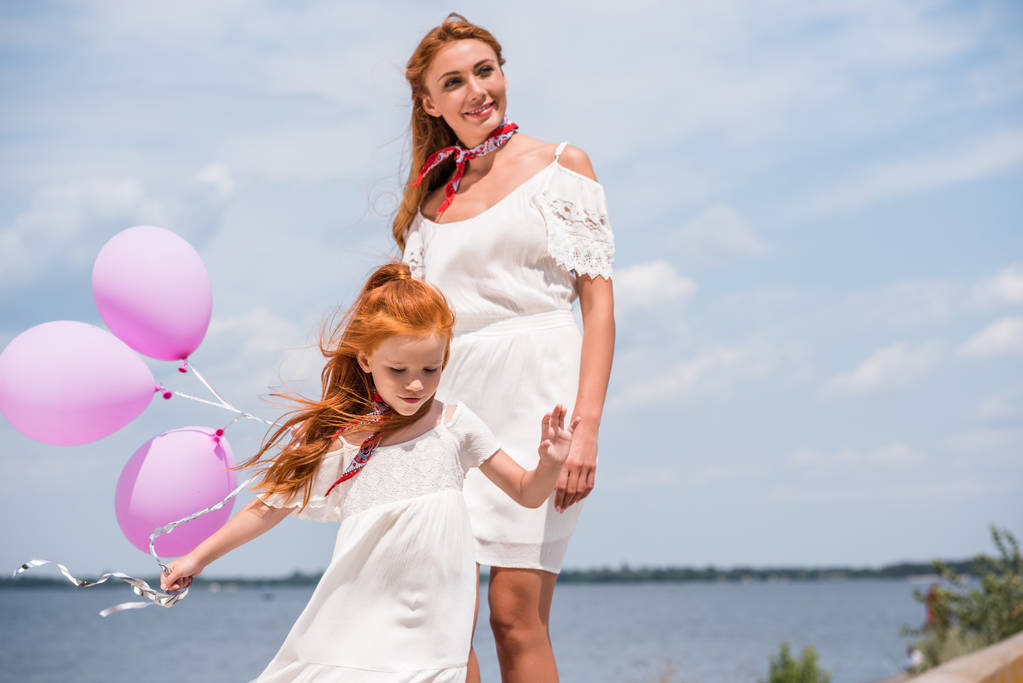mother and daughter with balloons - Photo, Image