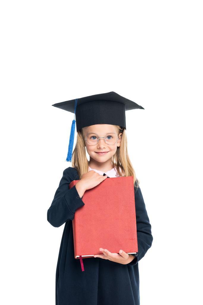 colegiala en sombrero de graduación con libro grande
 - Foto, Imagen