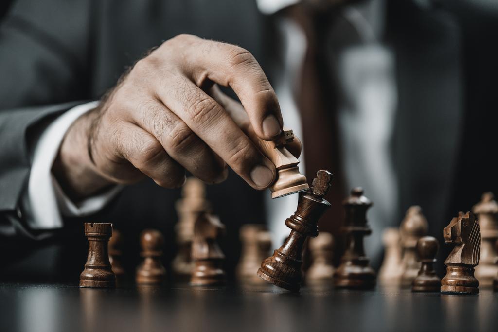 zakenman en chess cijfers op tafel - Foto, afbeelding