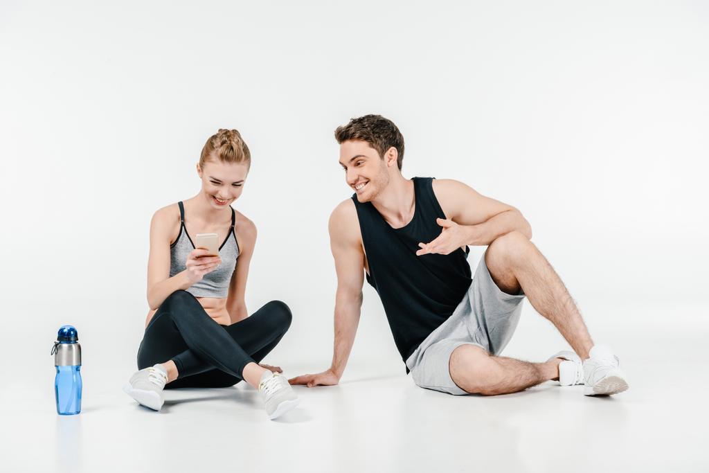 couple looking at phone after workout - Photo, Image