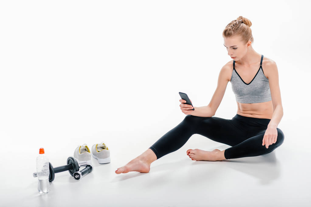 girl using phone after workout - Photo, Image