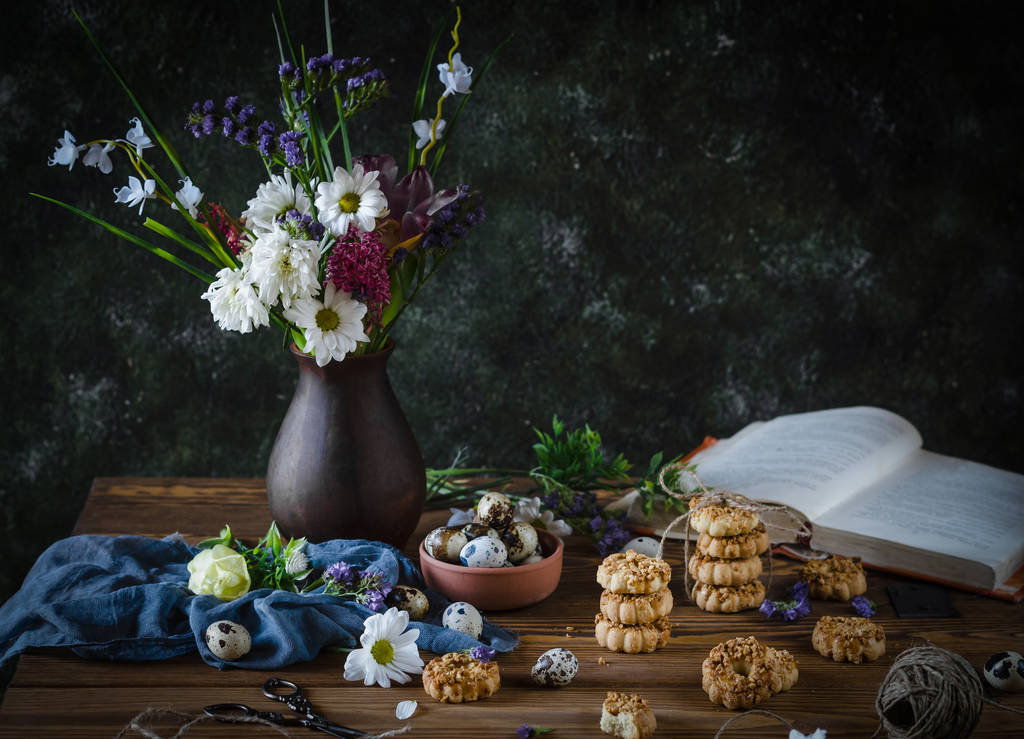 Quail eggs, walnuts, cookies and book - Photo, Image