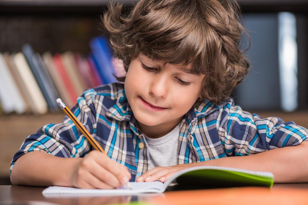 kid writing in copybook - Photo, Image