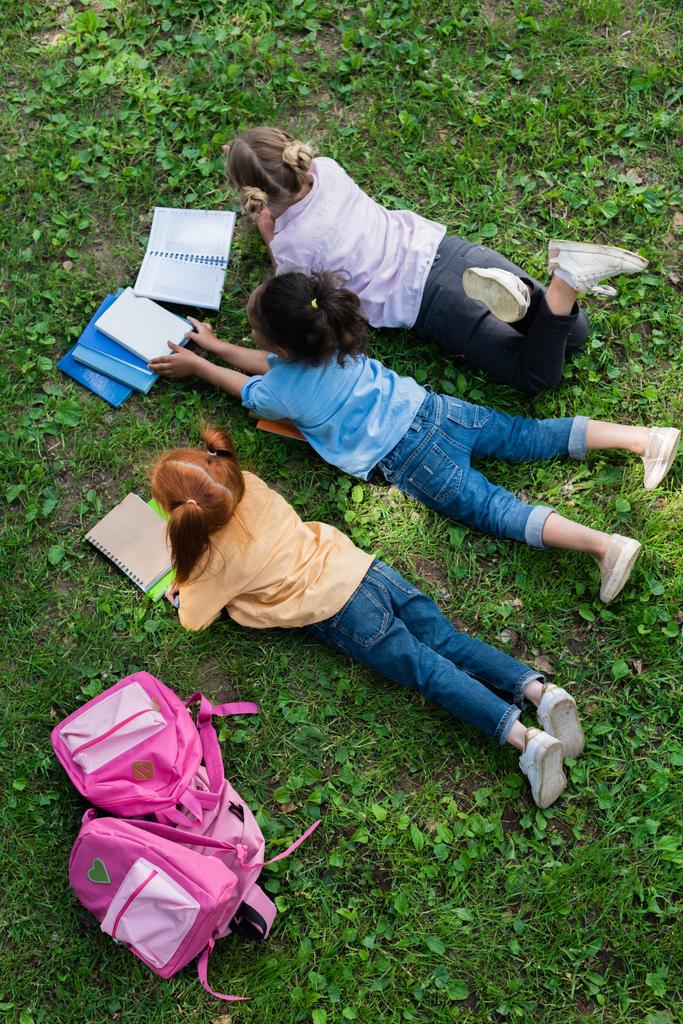 kids reading books in park - Photo, Image