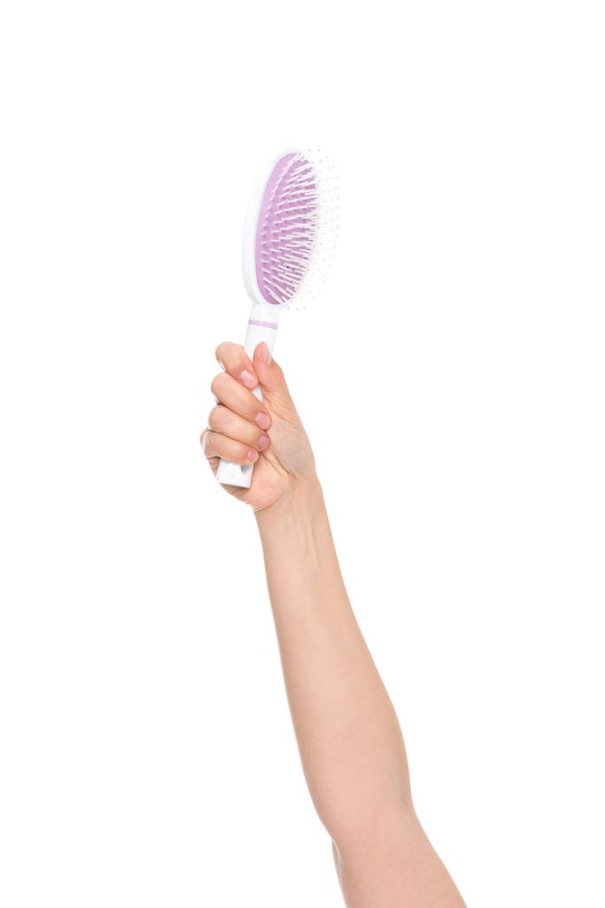 Mão segurando escova de cabelo
 - Foto, Imagem