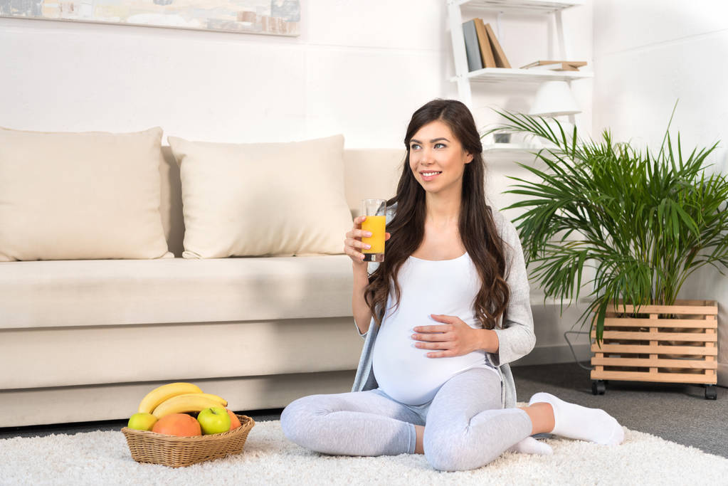 Donna incinta che tiene il bicchiere di succo
 - Foto, immagini