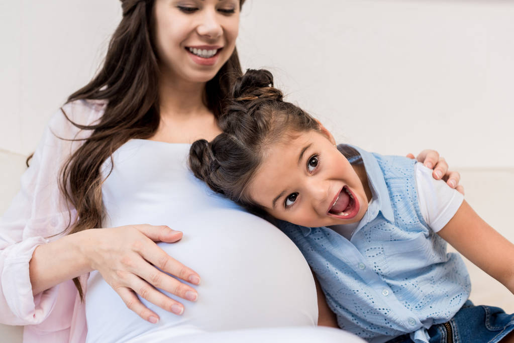 Belly terhes anya hallgat lány - Fotó, kép