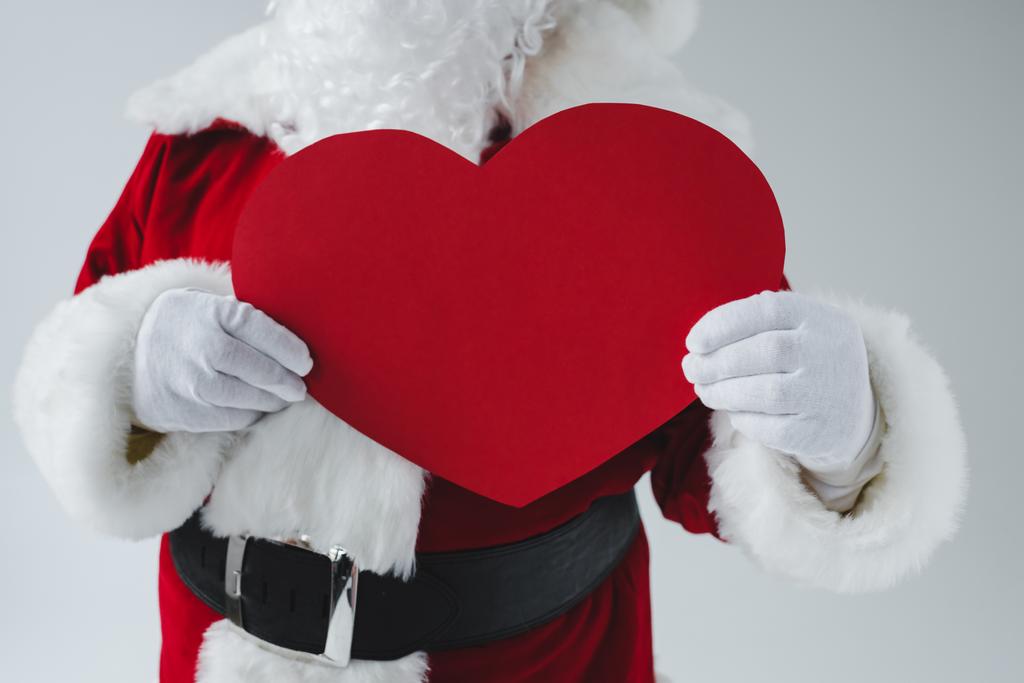 Санта тримає символ серця
 - Фото, зображення