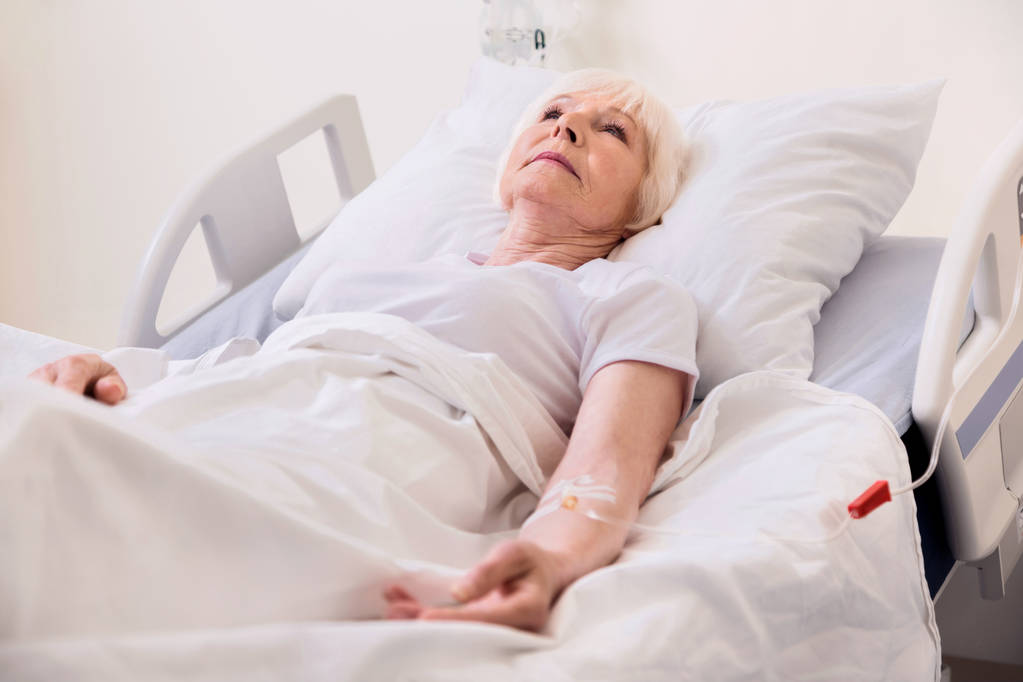 Kwetsbare zieke senior dame wordt behandeld in het ziekenhuis - Foto, afbeelding