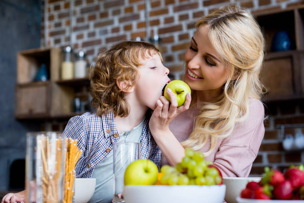 mother and son with apple - Photo, Image