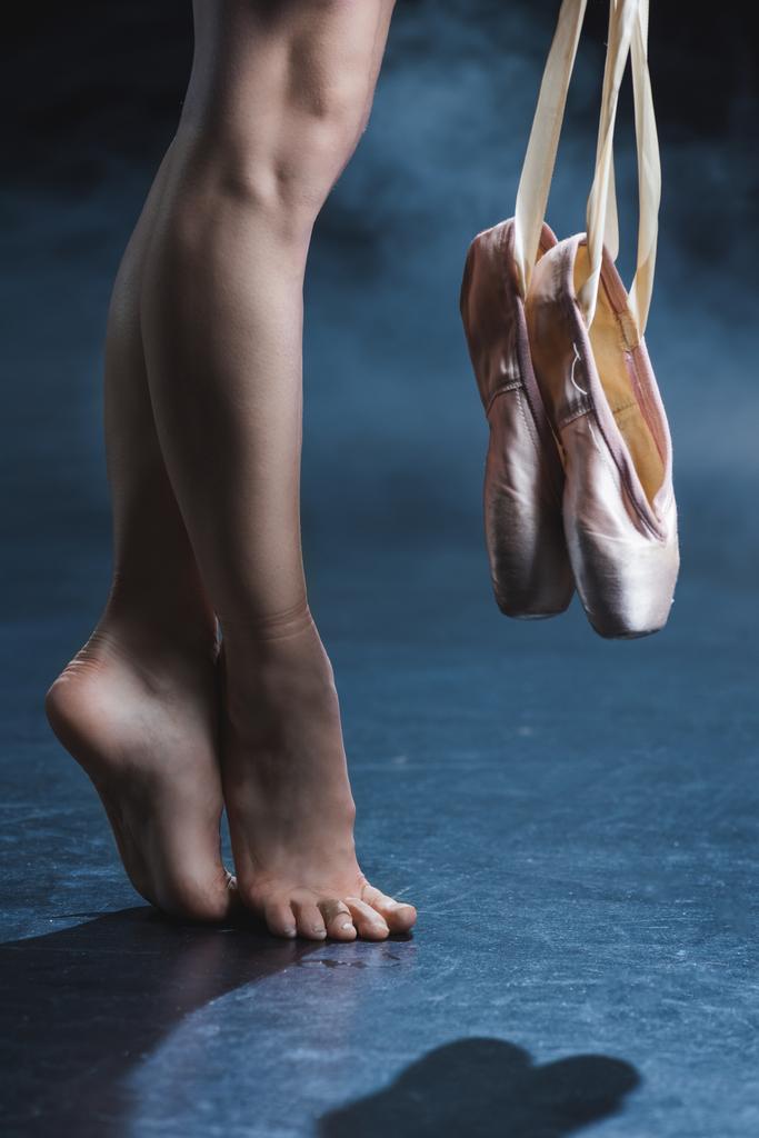 barefoot ballerina holding pointe shoes - Photo, Image