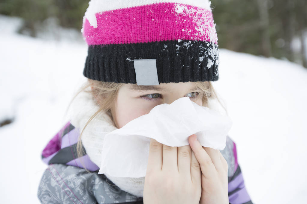 child with tissue outside in forest winter season - Photo, Image