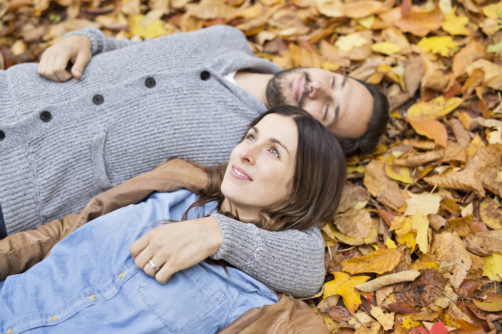 秋の公園で楽しんで素敵なカップル - 写真・画像