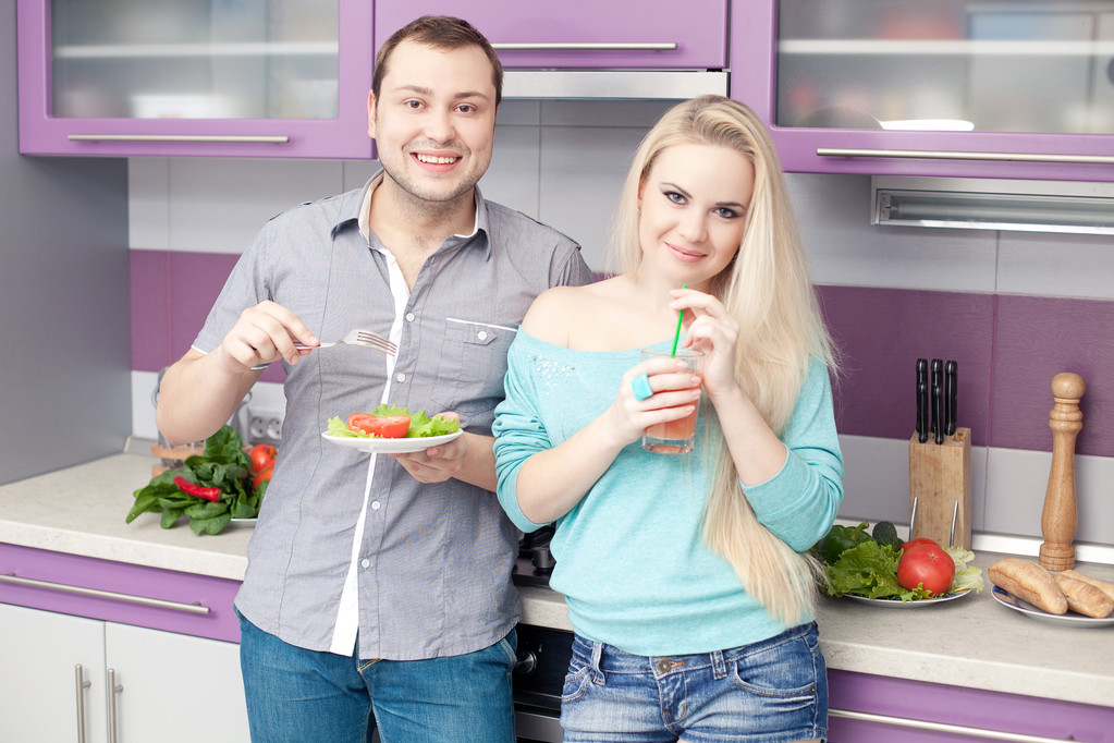 Portrait of a cute young couple preparing eating healthy breakfa - Photo, Image