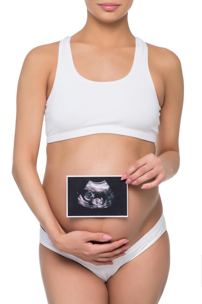 Zwangere vrouw met echo scan - Foto, afbeelding