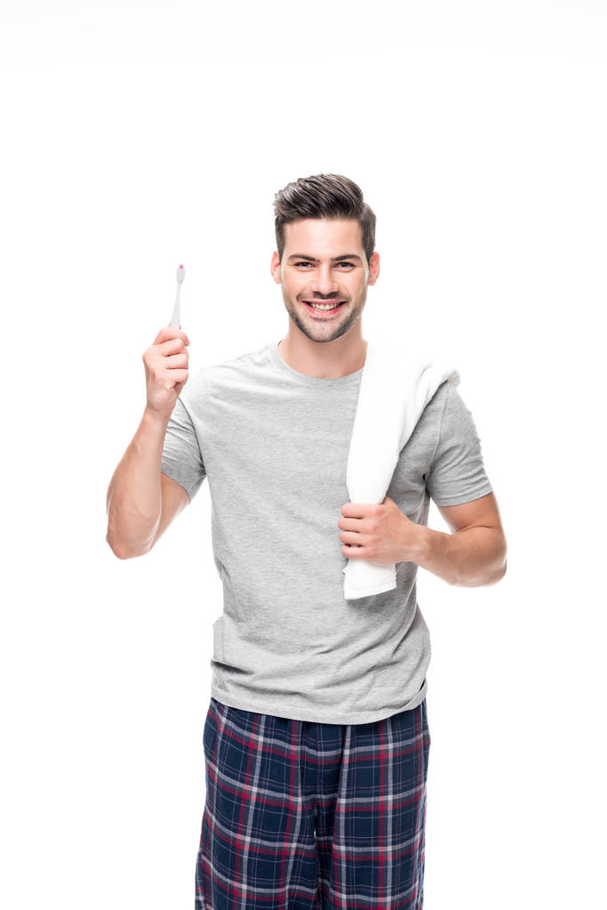 hombre con cepillo de dientes y toalla
 - Foto, imagen
