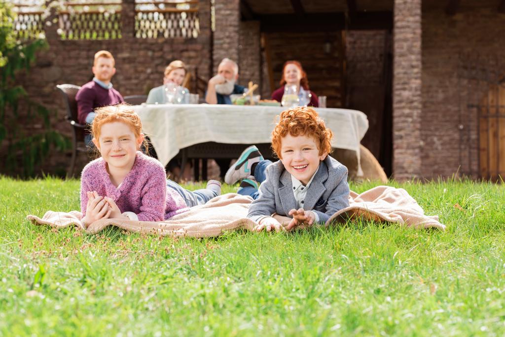 kids resting on green grass - Photo, Image