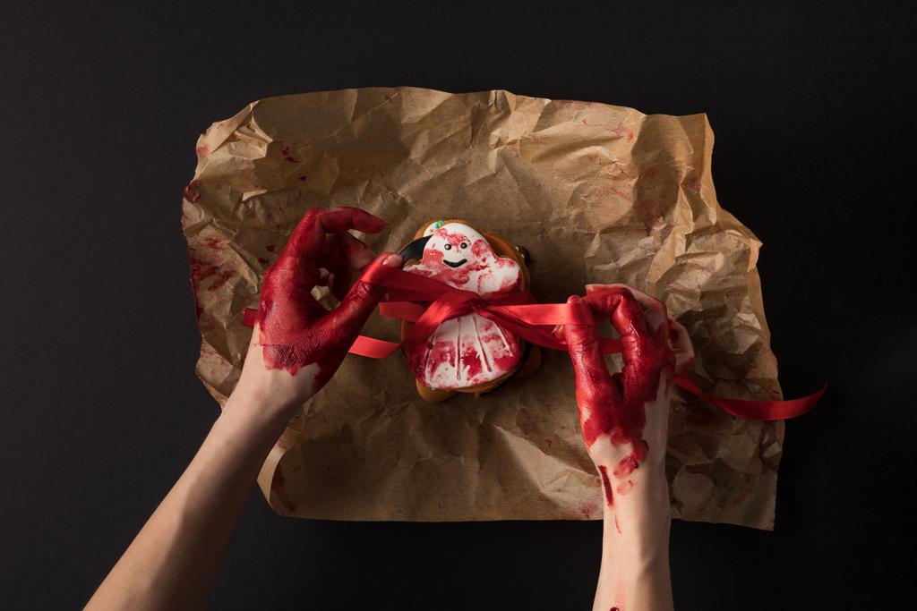 hands wrapping halloween cookie - Photo, Image