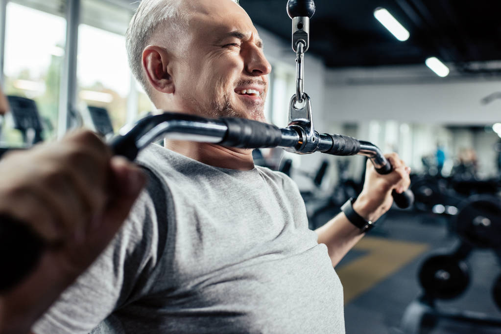 senior sportsman lifting weights - Photo, Image